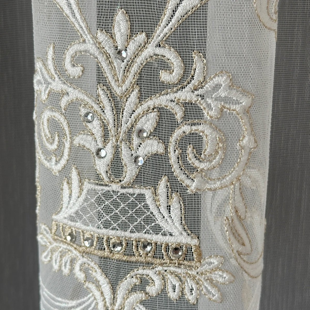 Decorative lace curtains fabric with damask floral patterns and embellishments on a plain background