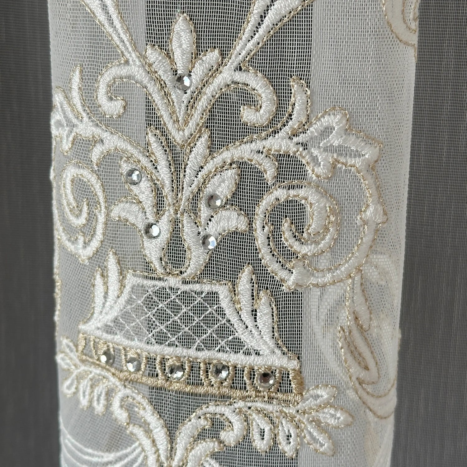 Decorative lace curtains fabric with damask floral patterns and embellishments on a plain background