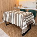 Dining table with a striped tablecloth in a home setting