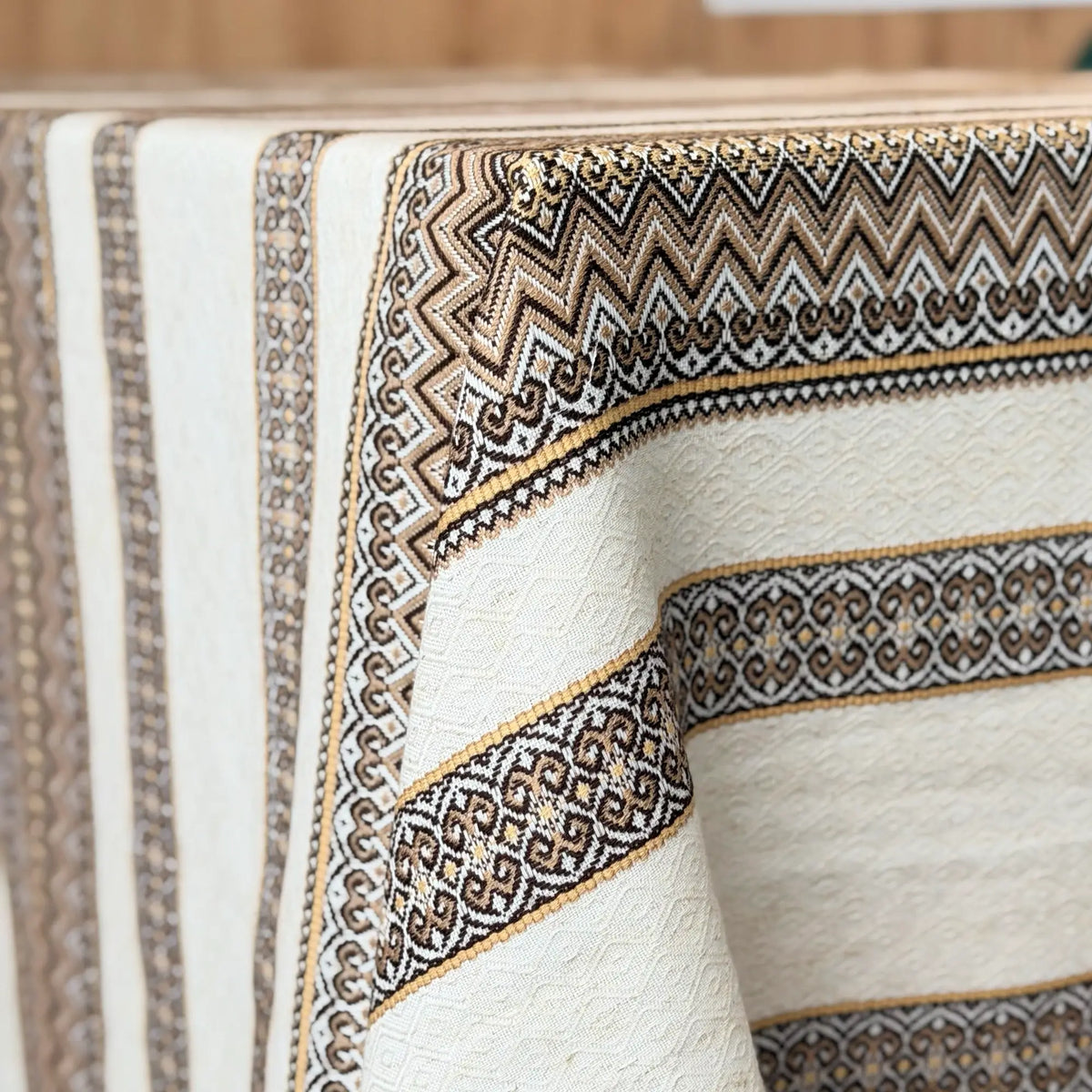 Close-up of a textured fabric with intricate patterns and embroidery.