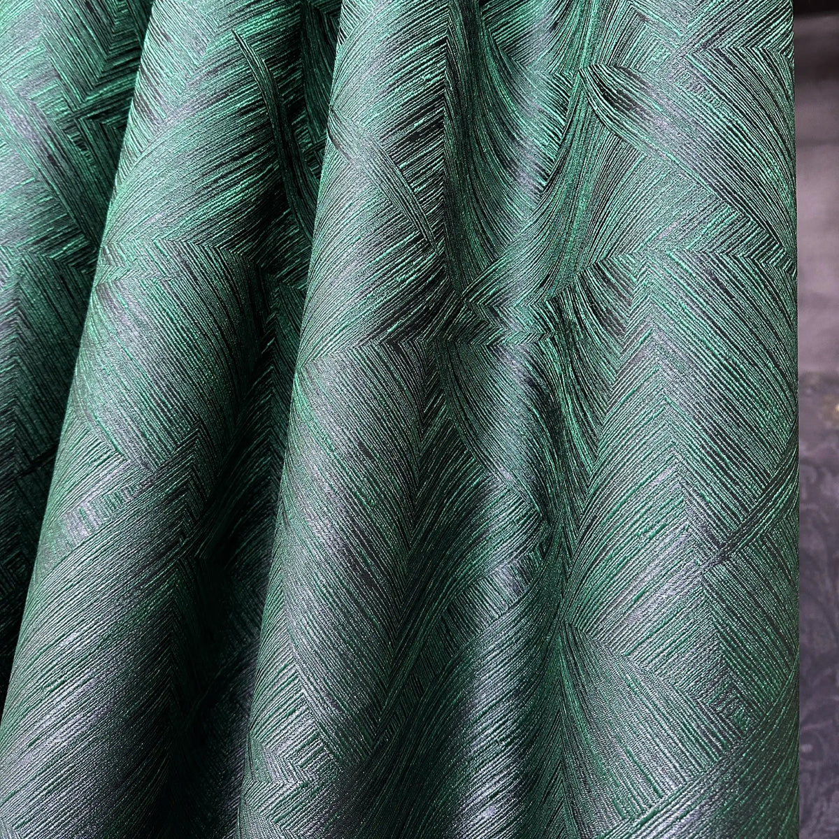 Close-up of green textured fabric with a geometric pattern