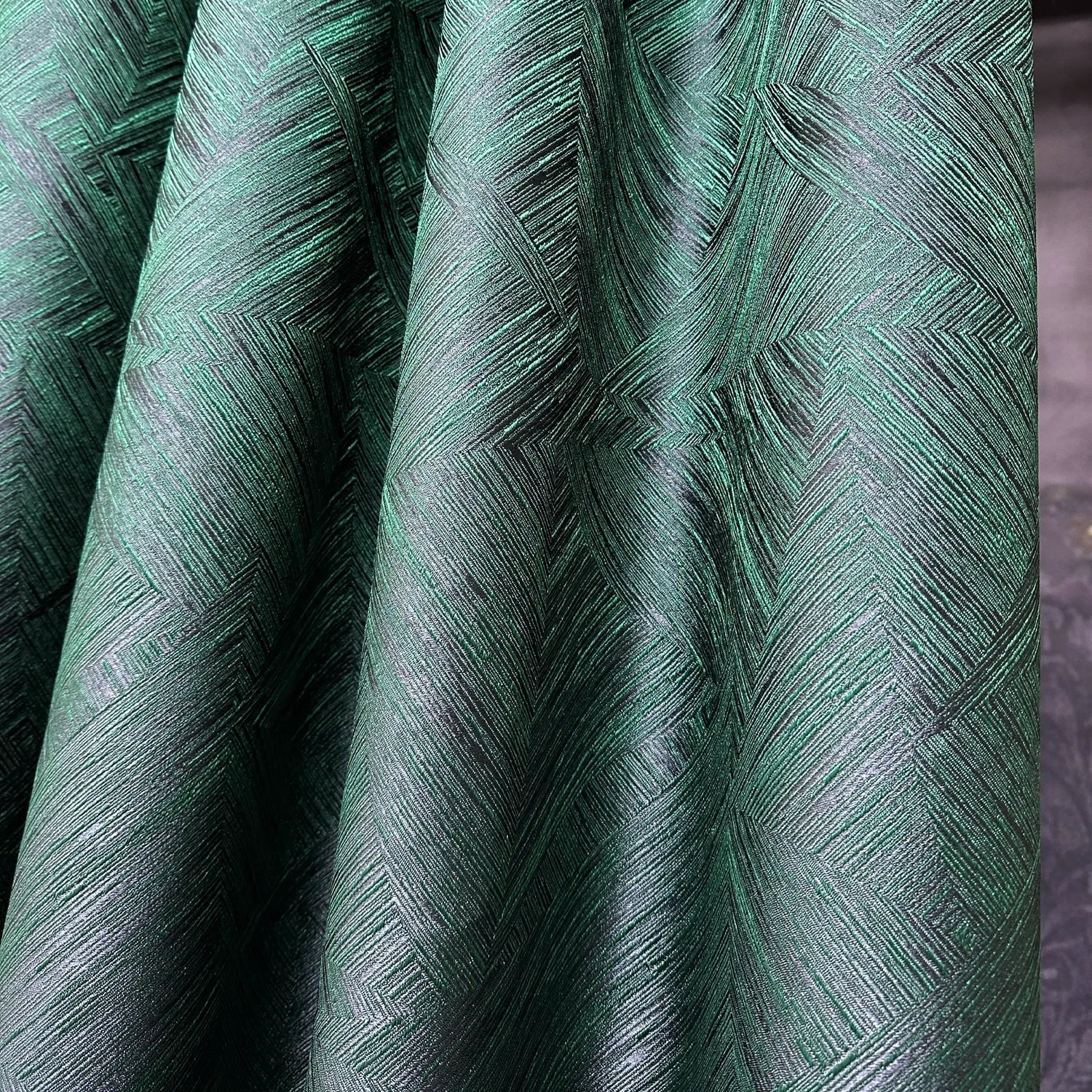 Close-up of green textured fabric with a geometric pattern