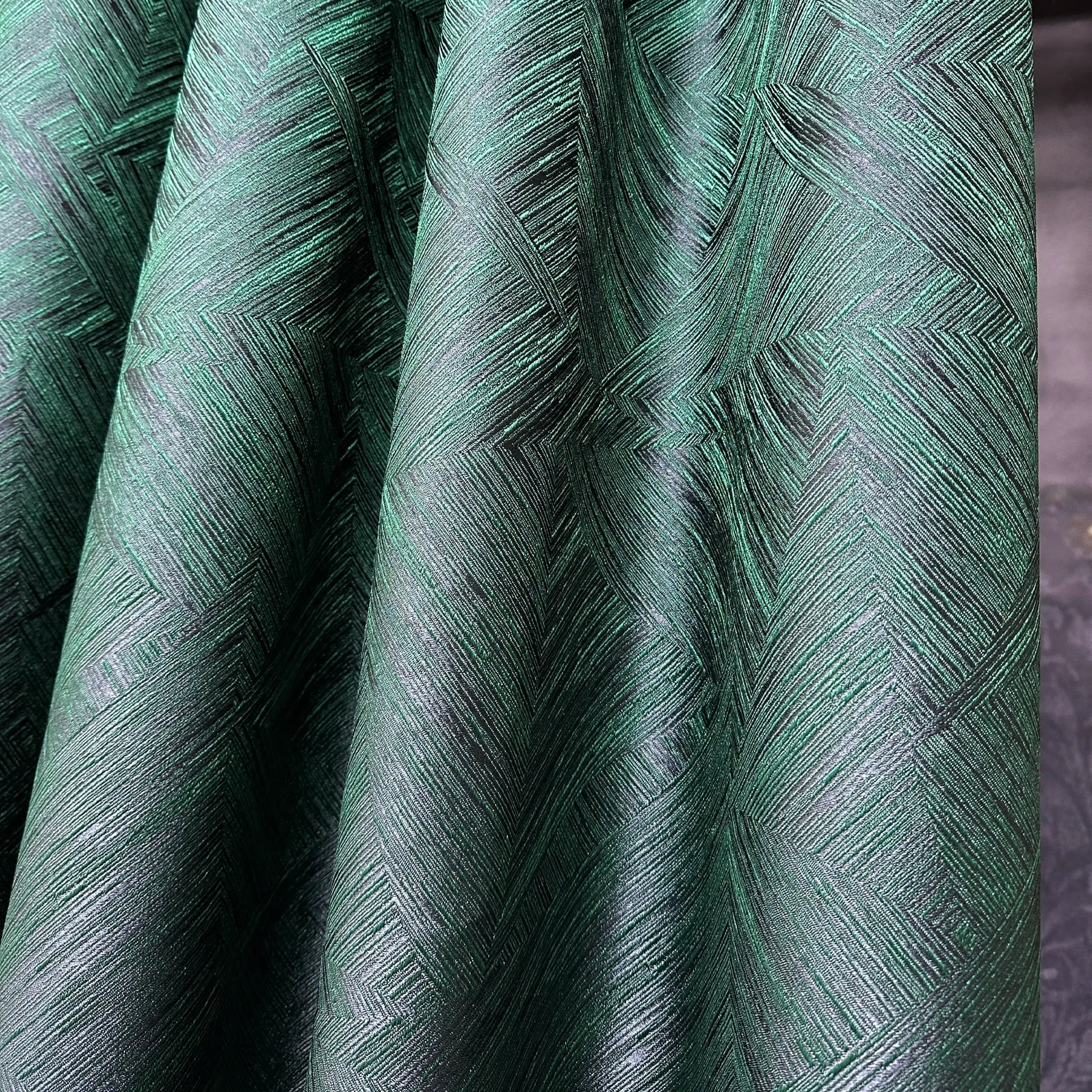 Close-up of green textured fabric with a geometric pattern