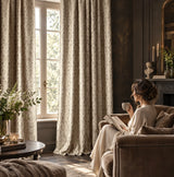 Beige bohemian damask jacquard curtains with vintage floral pattern hanging beside a living room window