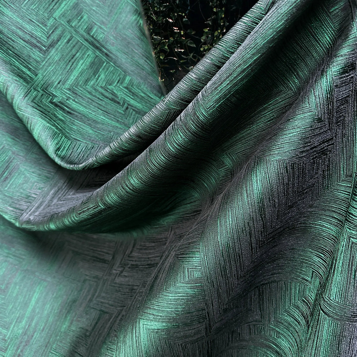 Close-up of textured green fabric with geometric pattern