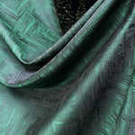 Close-up of textured green fabric with geometric pattern