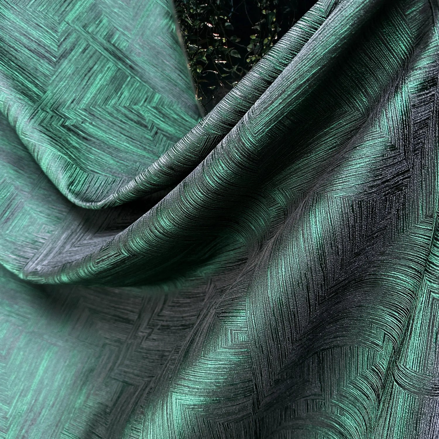 Close-up of textured green fabric with geometric pattern