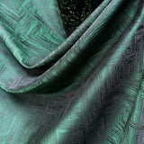 Close-up of textured green fabric with geometric pattern