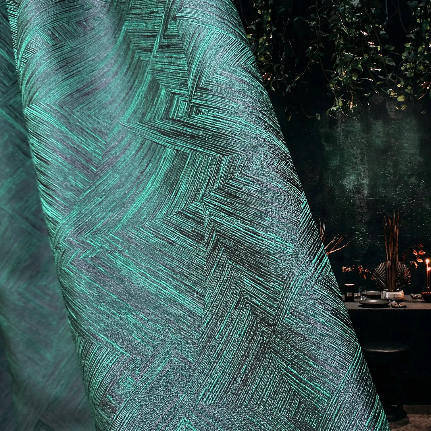 Close-up of a textured green fabric with a geometric pattern, blurred background