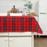 Red plaid tablecloth on a kitchen counter with a blurred background