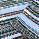 Close-up of patterned fabric with geometric designs on a light blue background