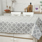 Gray geometric patterned tablecloth on a dining table in a kitchen setting.