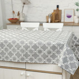 Gray geometric patterned tablecloth on a dining table in a kitchen setting.