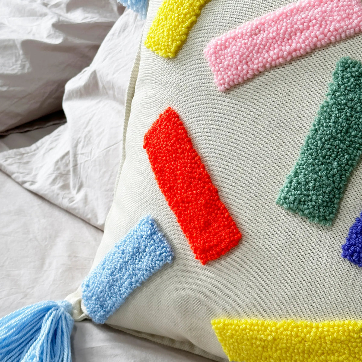 Pillow Cover with Tassels punch needle close up photo