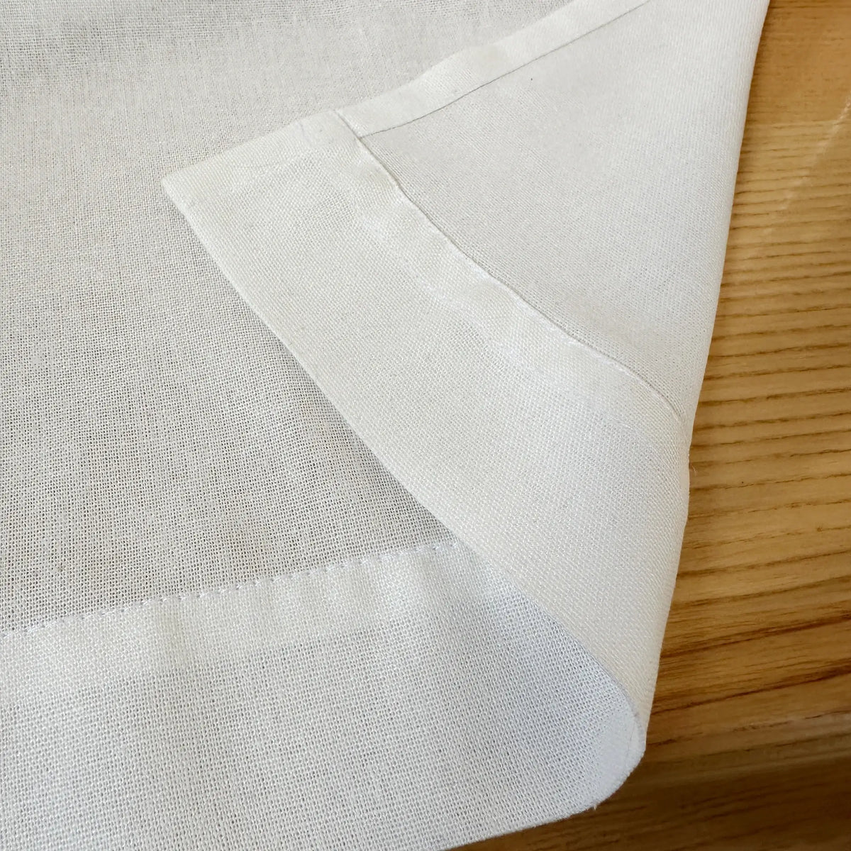 Close-up of white fabric on a wooden surface
