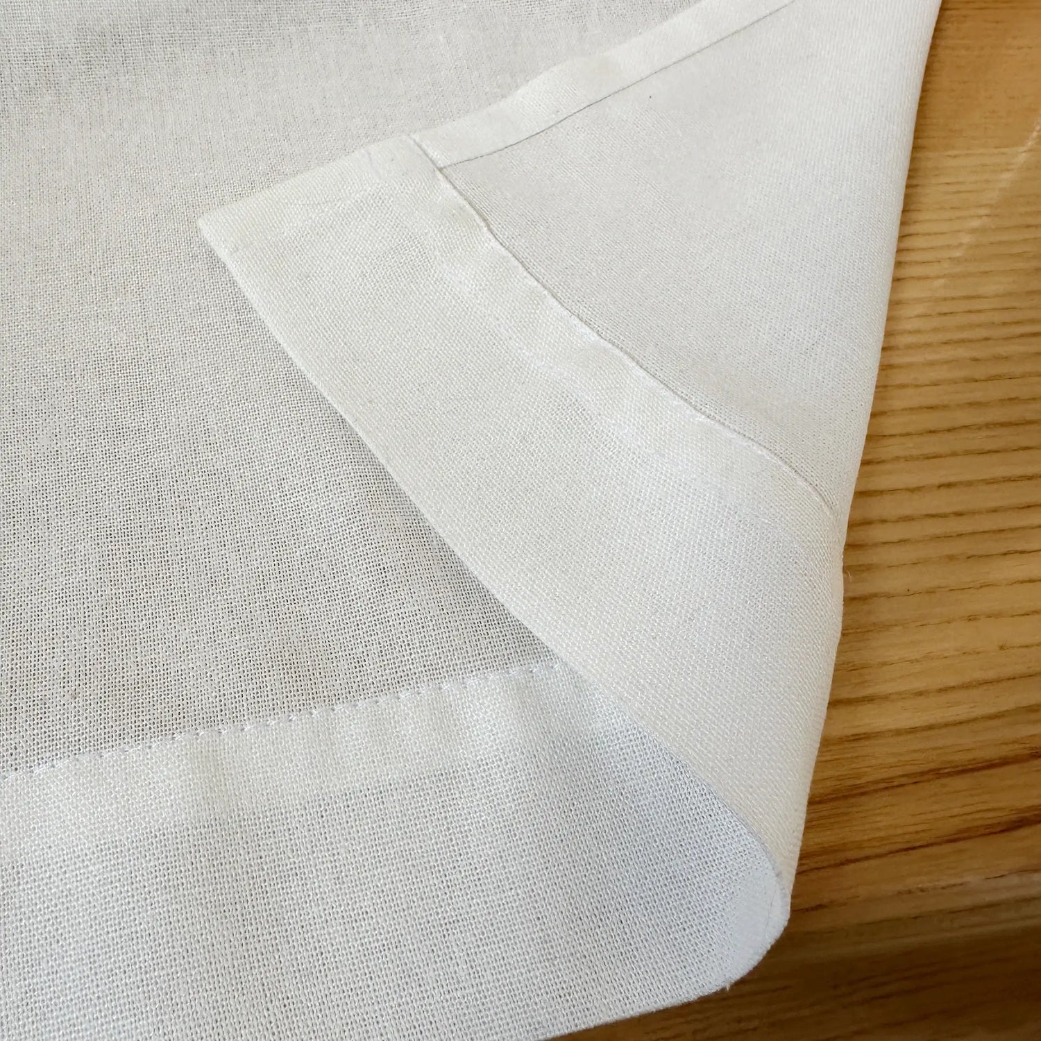 Close-up of white fabric on a wooden surface