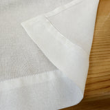Close-up of white fabric on a wooden surface
