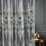 Decorative lace curtain with intricate patterns on a dark background