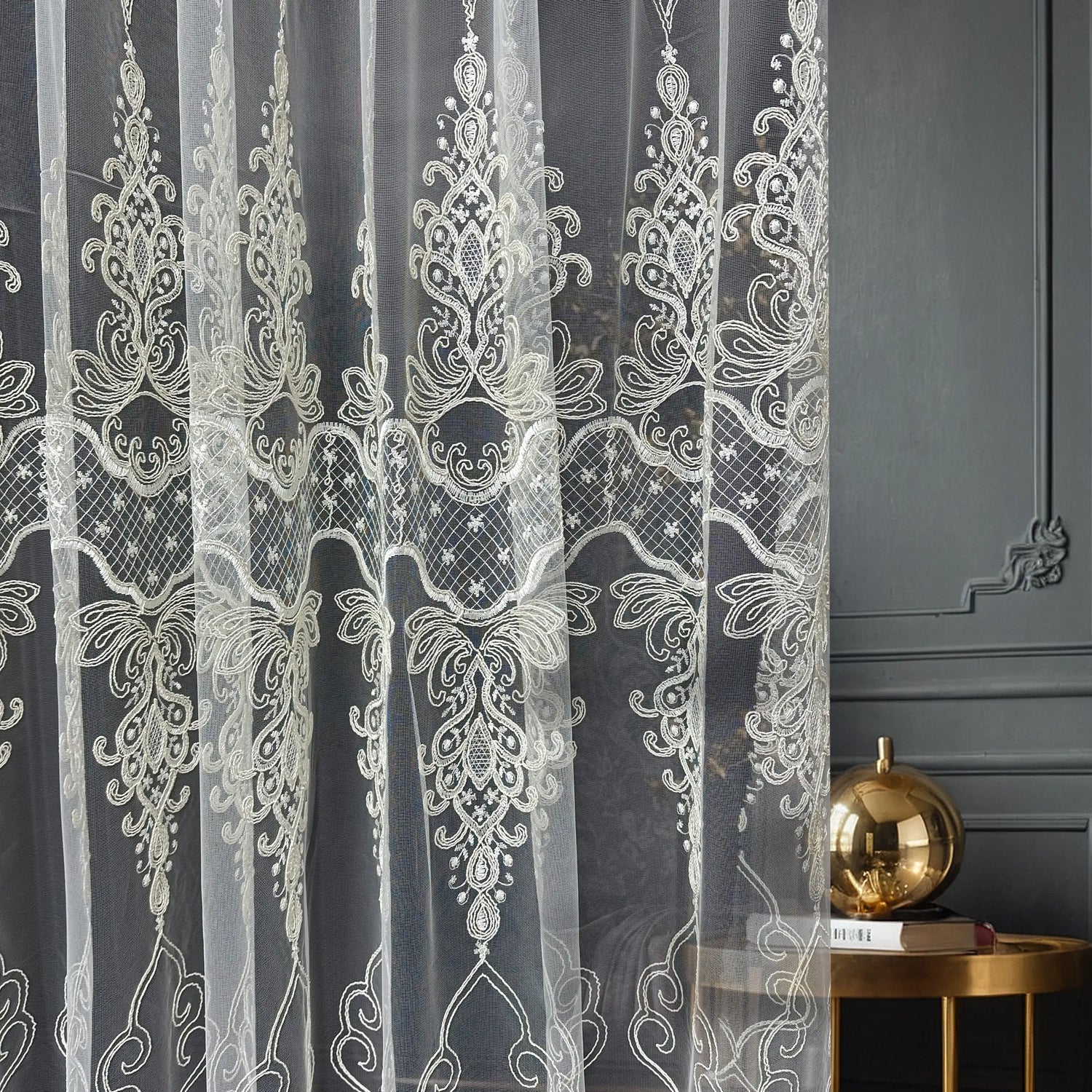 Decorative lace curtain with intricate patterns on a dark background