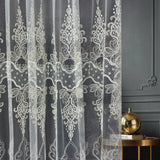 Decorative lace curtain with intricate patterns on a dark background
