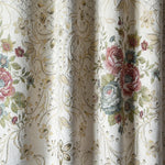 Floral and paisley patterned fabric with embroidered roses.