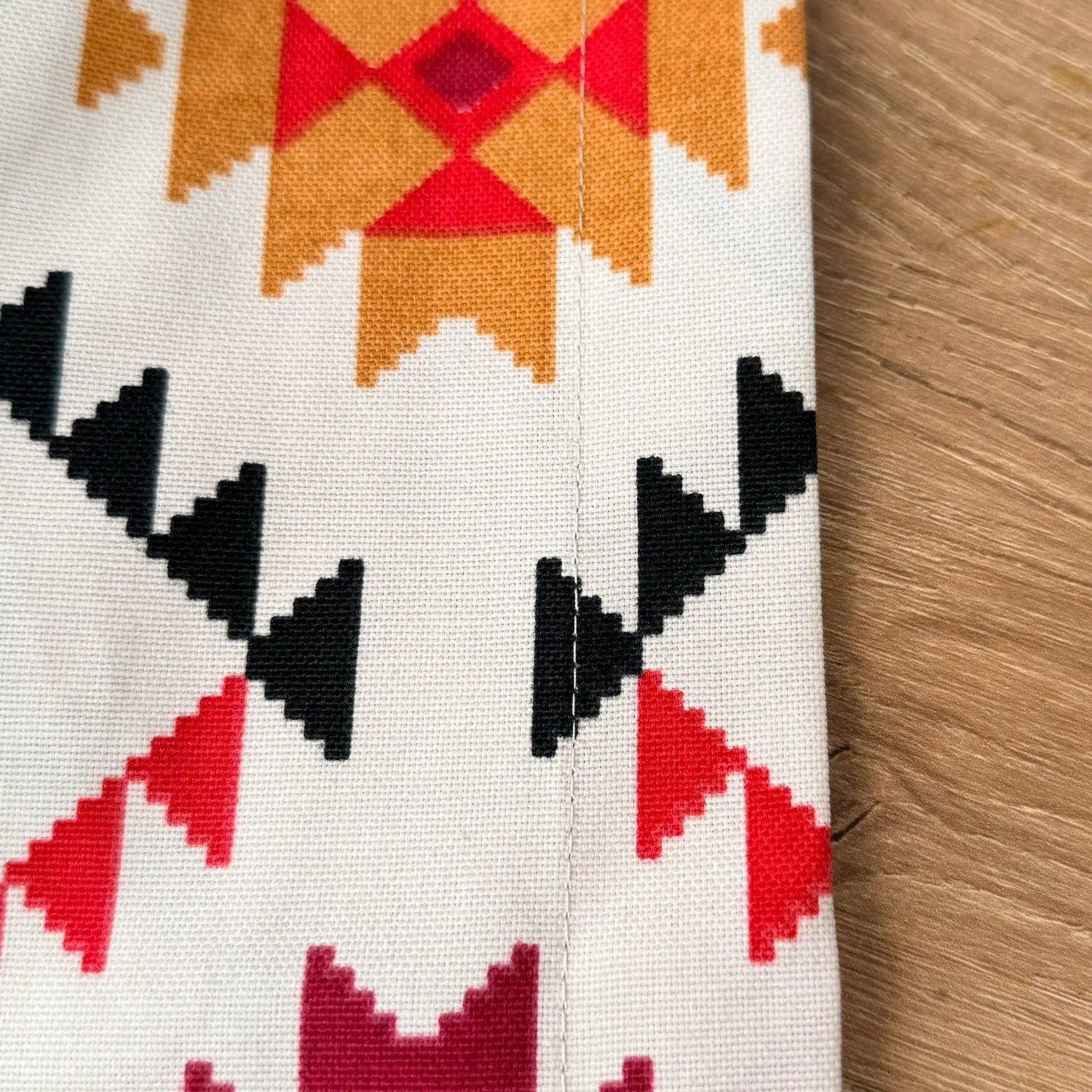 Close-up of a fabric with geometric pattern on a wooden surface