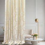 Decorative beige curtain in a stylish room with a chair and table.