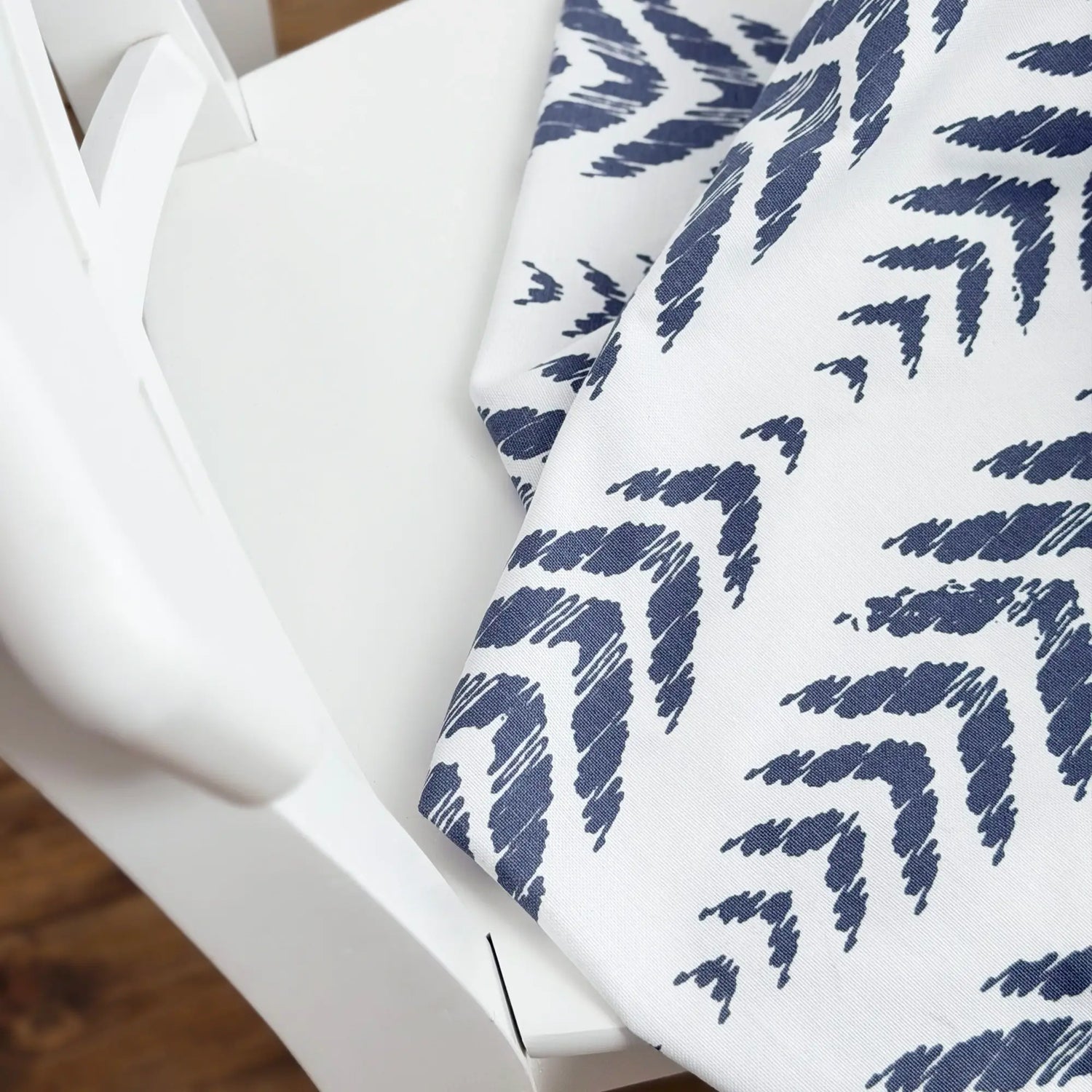 Navy blue leaf pattern on a white fabric swatch