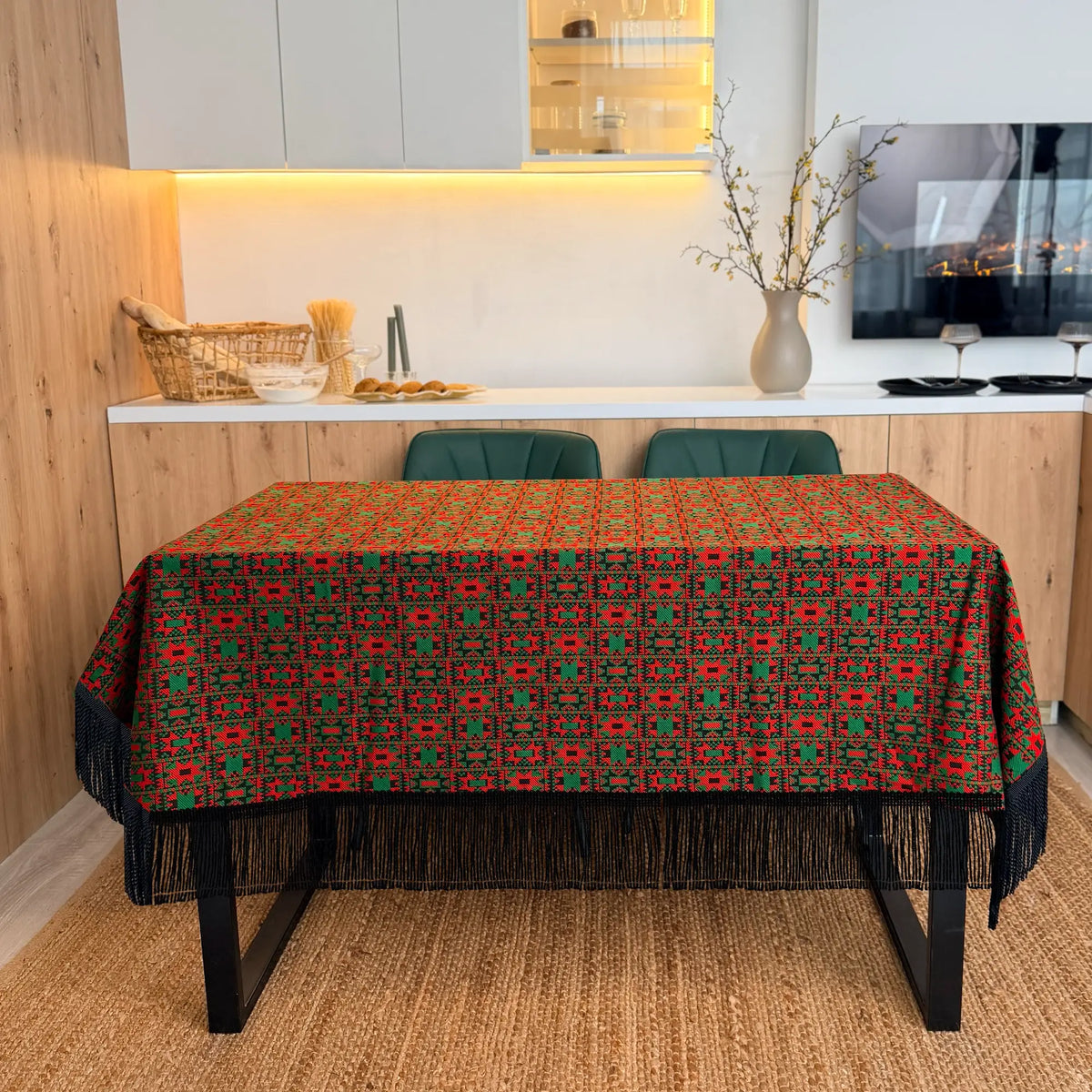 Dining table with a patterned tablecloth in a modern kitchen setting