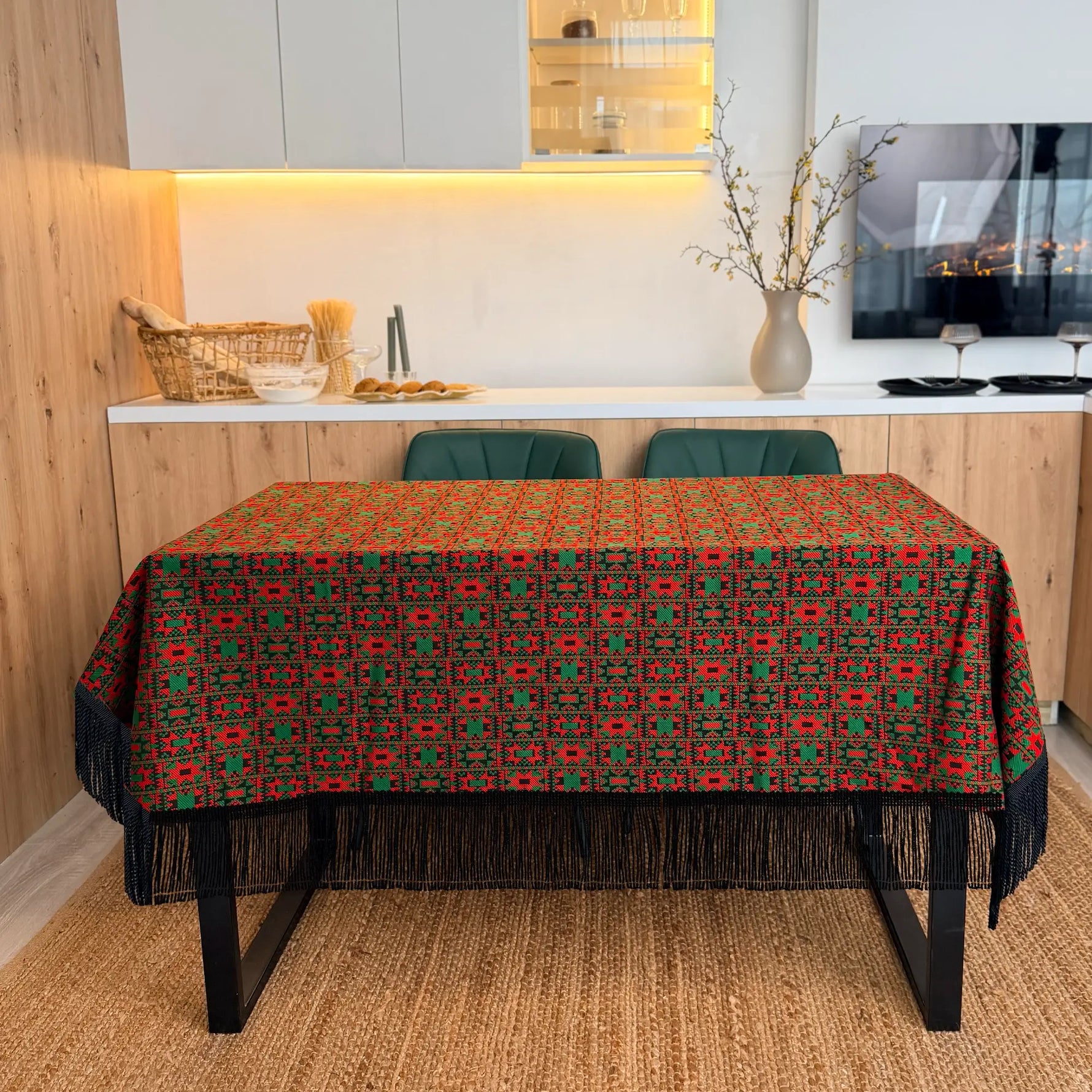 Dining table with a patterned tablecloth in a modern kitchen setting