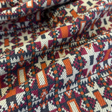 Close-up of patterned fabric with geometric design in multicolors