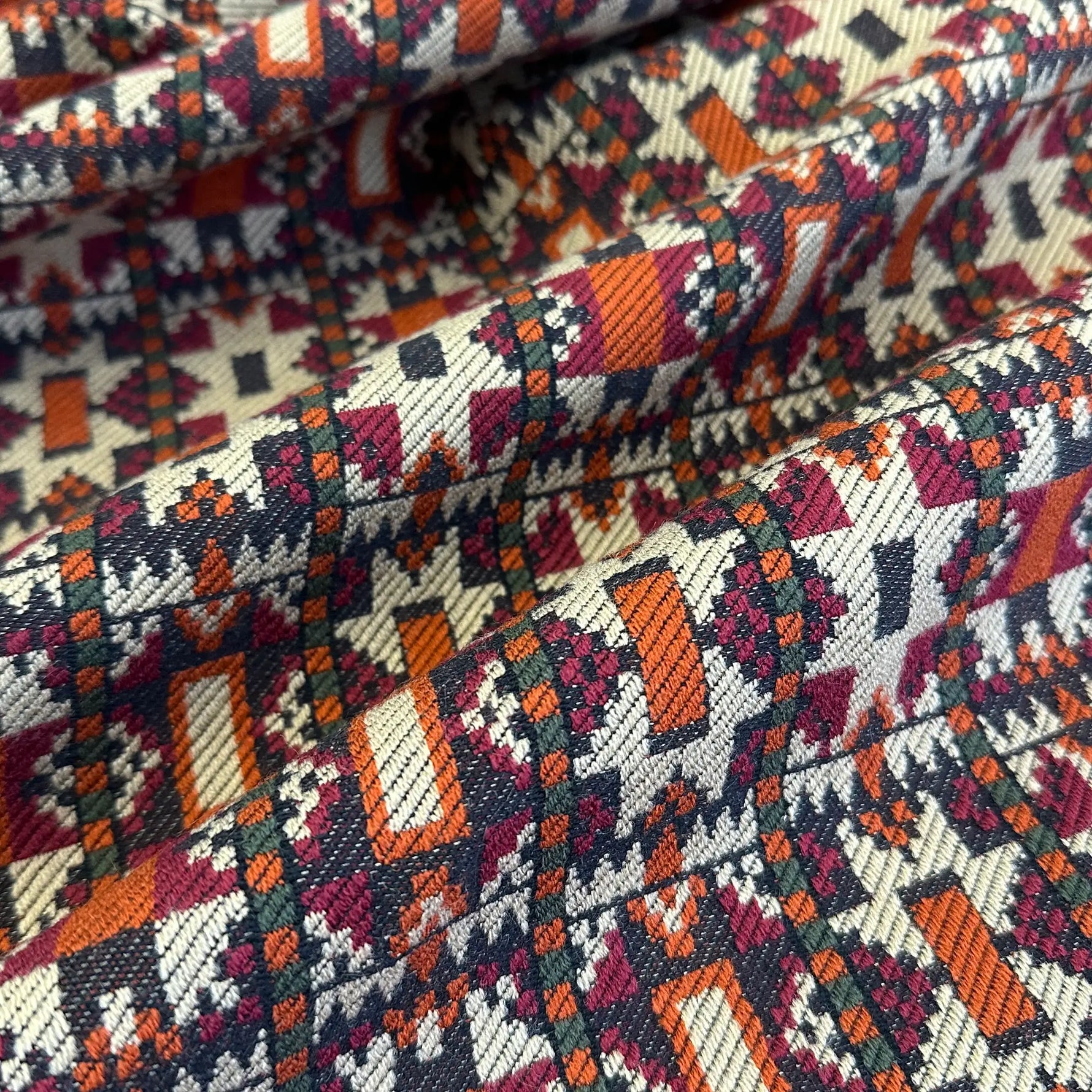 Close-up of patterned fabric with geometric design in multicolors