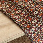 Close-up of a patterned rug on a wooden floor