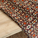 Close-up of a patterned rug on a wooden floor
