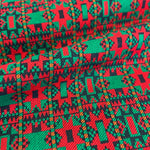 Close-up of fabric with a vibrant geometric pattern in red, green, and black.