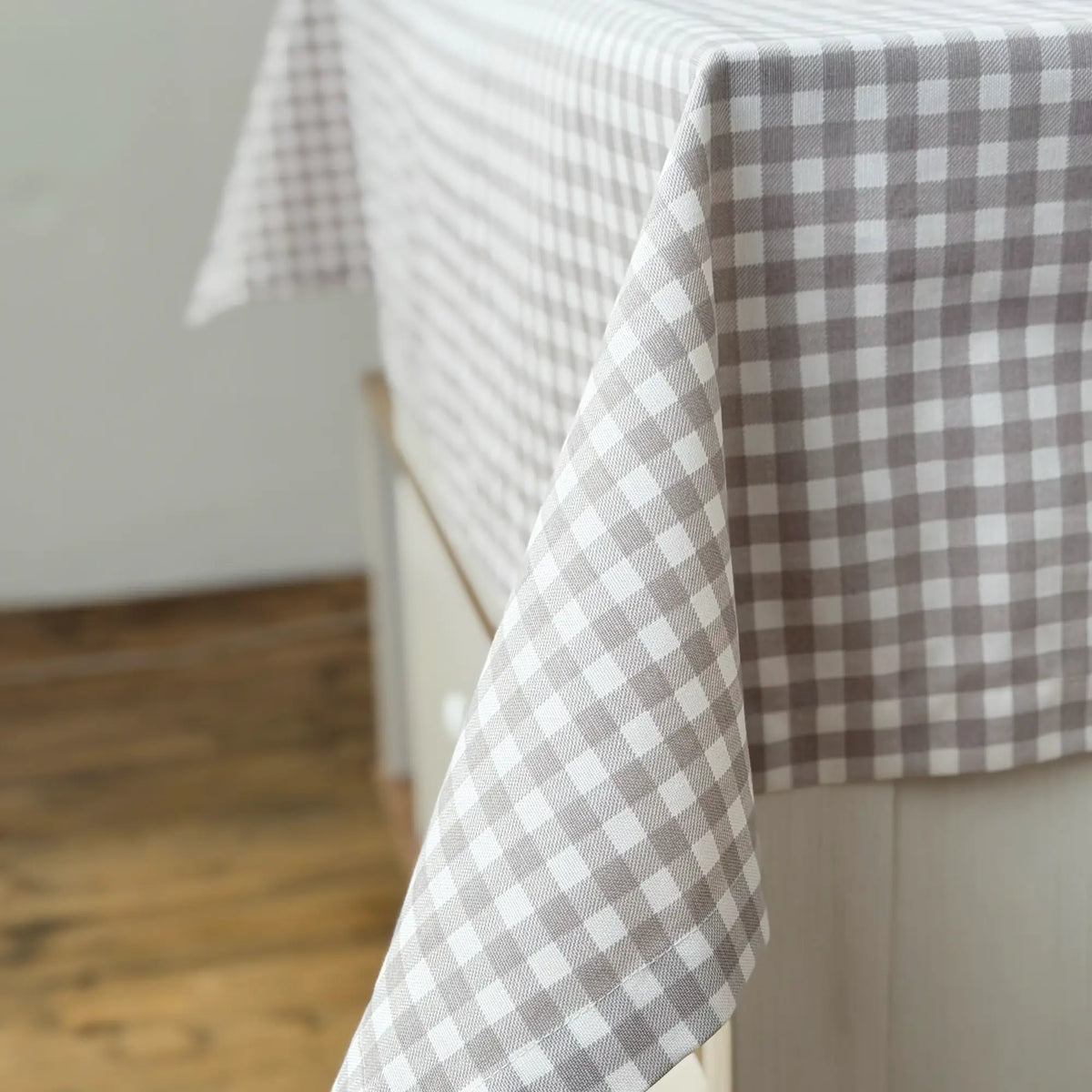 Gray and white checkered tablecloth on a wooden surface