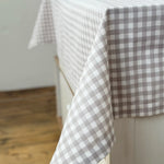 Gray and white checkered tablecloth on a wooden surface