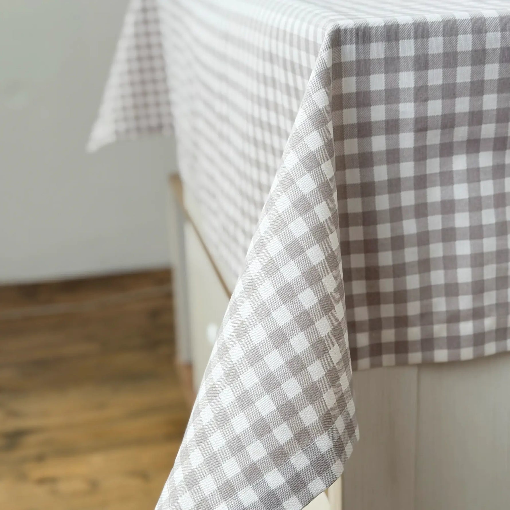 Gray and white checkered tablecloth on a wooden surface