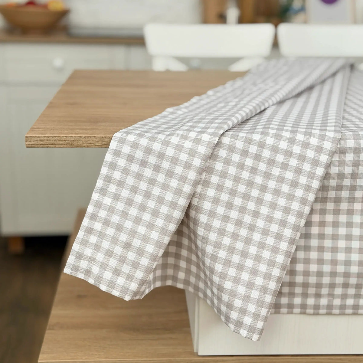 Checkered tablecloth on a wooden table in a kitchen setting