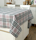 Plaid tablecloth on a kitchen table with white chairs