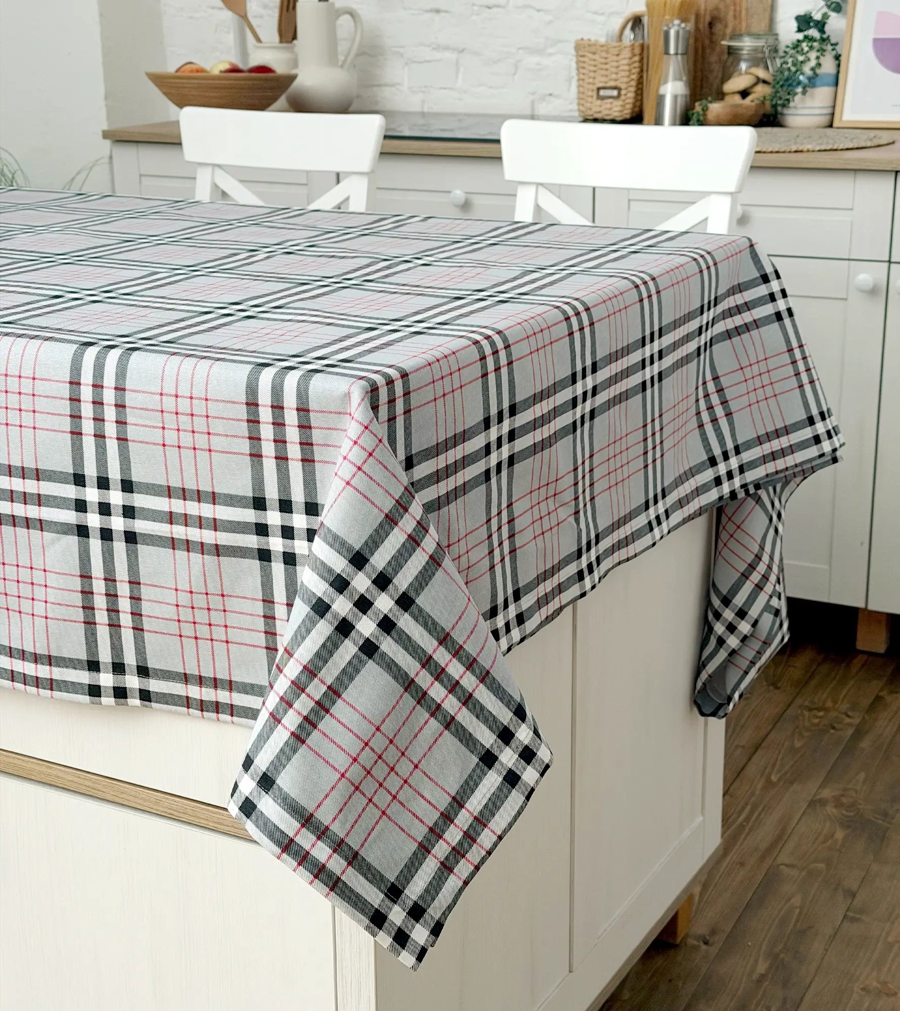 Plaid tablecloth on a kitchen table with white chairs