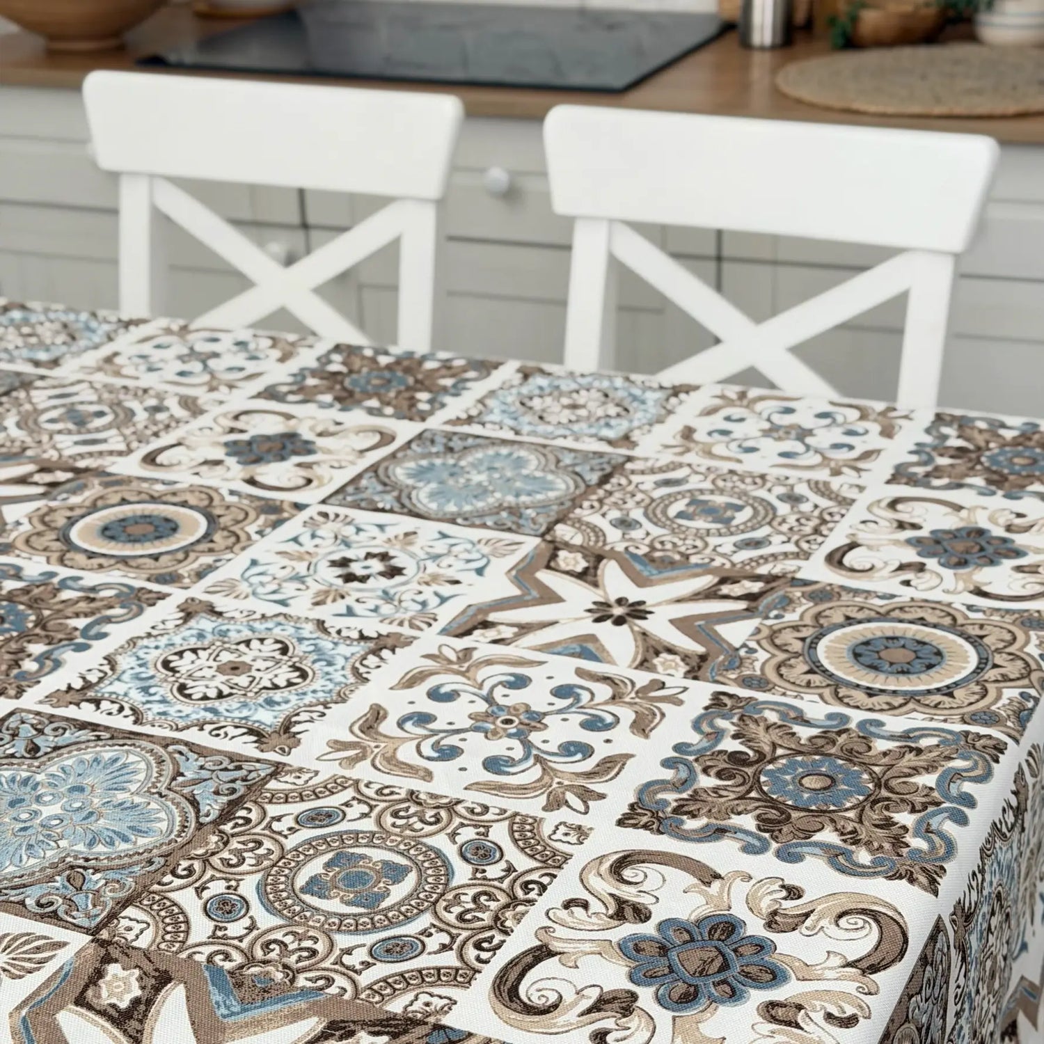 Tablecloth with decorative tile pattern on a table in a kitchen setting
