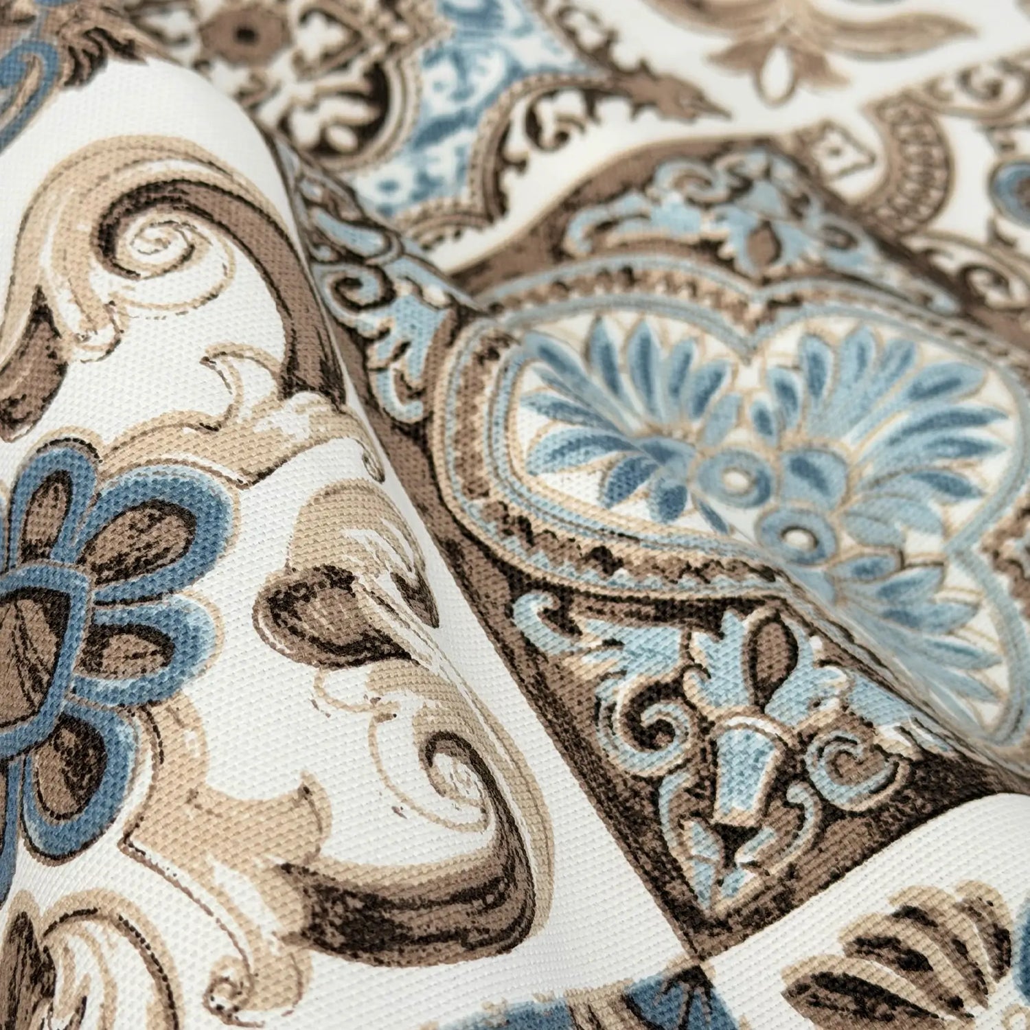 Close-up of a patterned fabric with blue and brown designs.