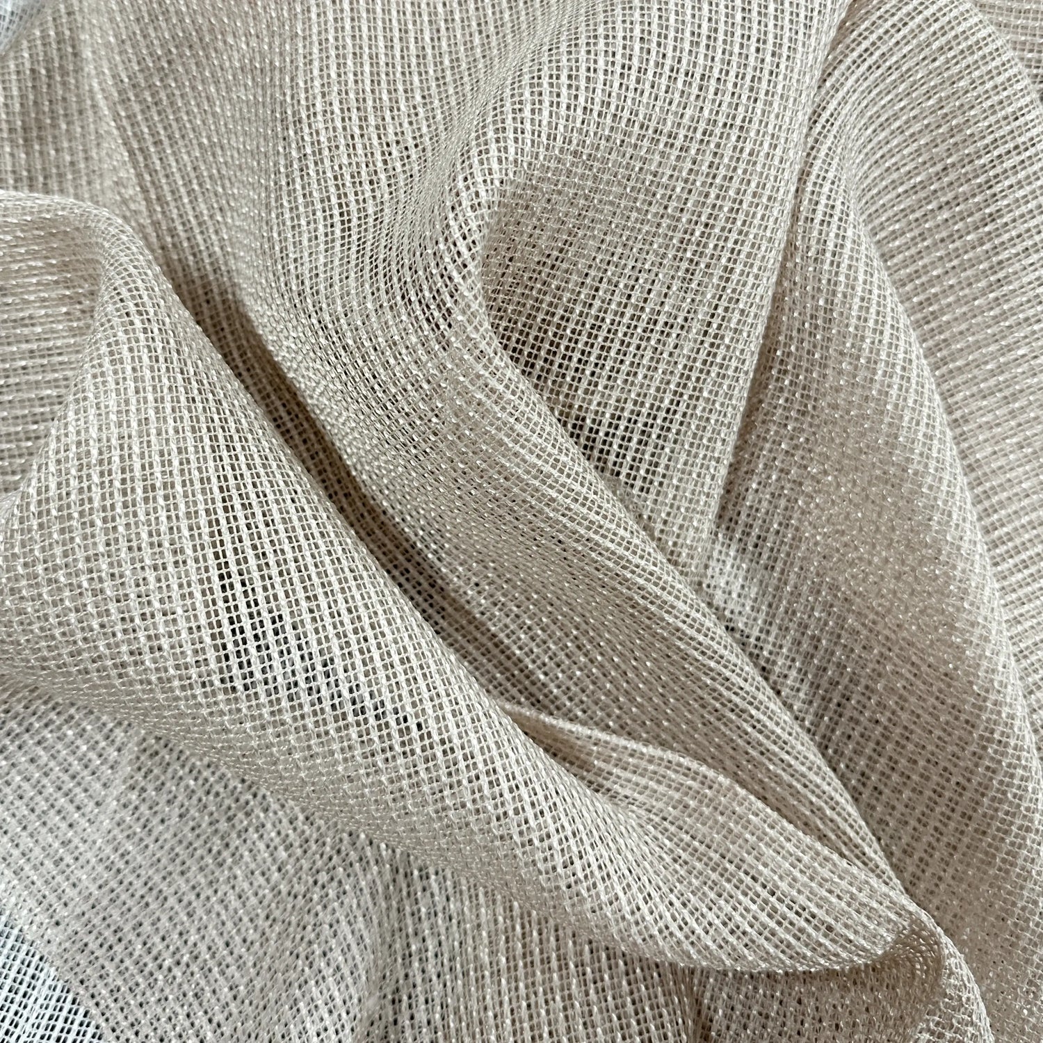 Close-up of beige curtains fabric with a textured pattern