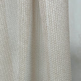 Close-up of textured beige curtains fabric with a subtle pattern