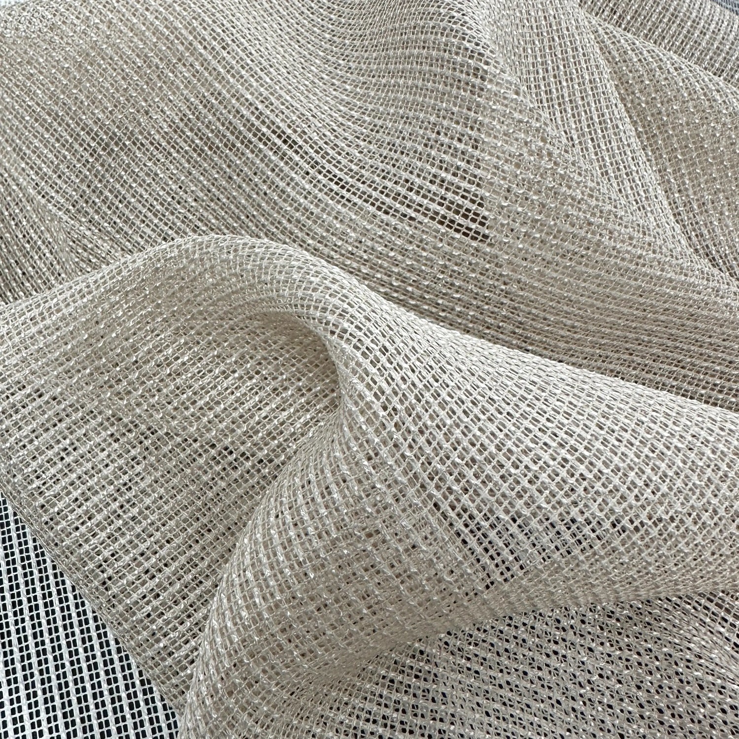 Close-up of textured beige curtains fabric with a subtle pattern, 