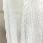 Close-up of a textured white pet friendly curtain
