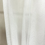 Close-up of a textured white pet friendly curtain