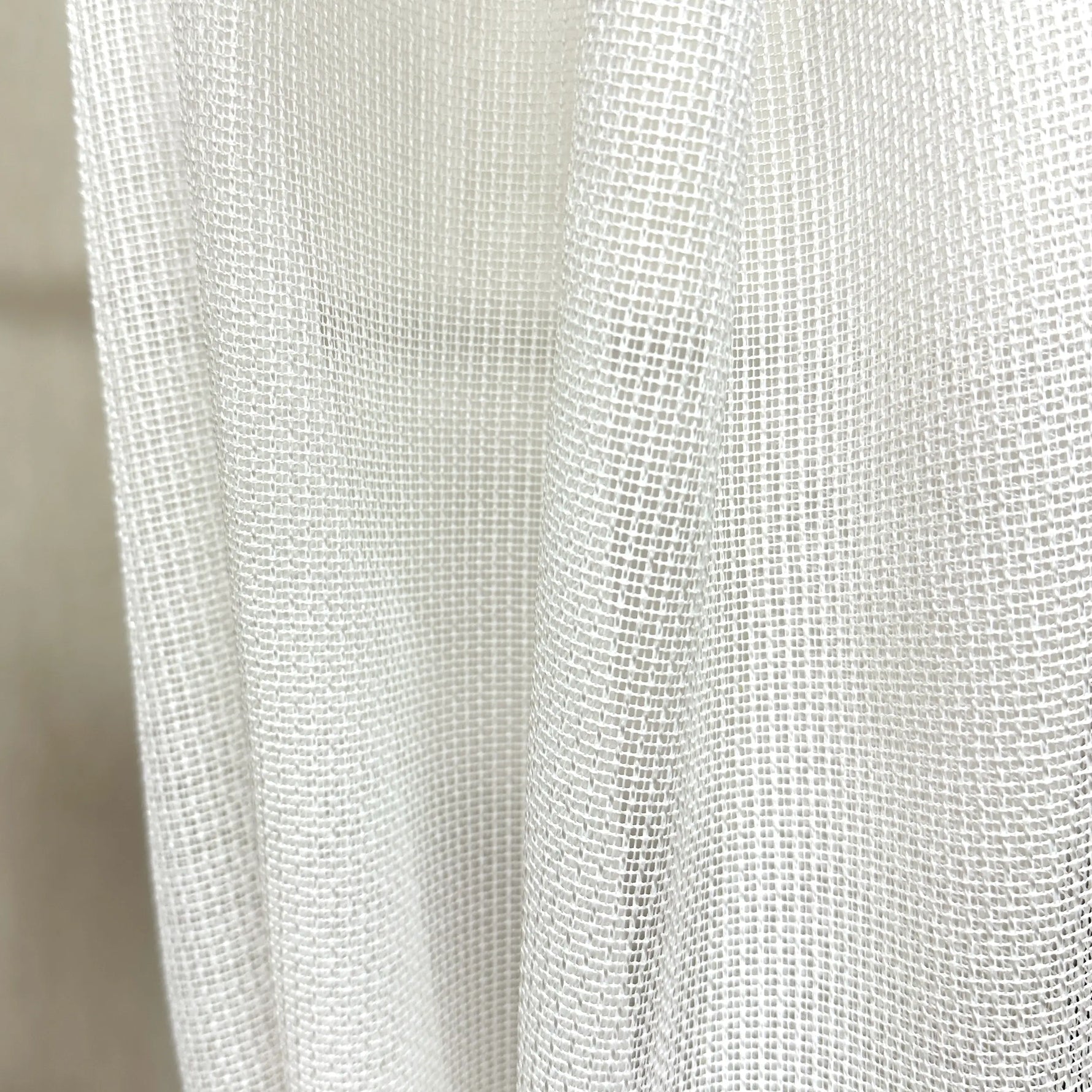 Close-up of a textured white pet friendly curtain