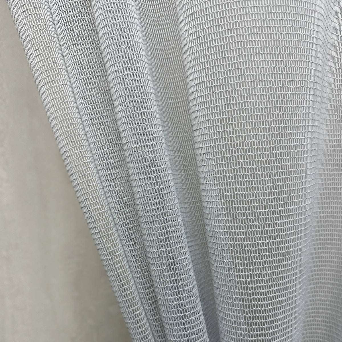 Close-up of a textured gray curtains fabric scratch proof on a neutral background